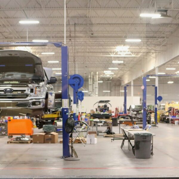 Skilled auto body technicians performing high-precision repairs at Network Auto Body's state-of-the-art facility.